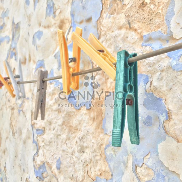 colorful clothespins hanged against wall - image #183145 gratis