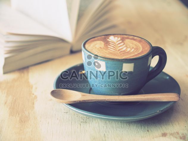 Coffee latte art and open book on wooden table - Free image #187075