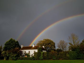 Landscape with rainbow over house - image #198235 gratis