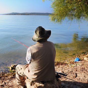 fisherman near the lake - image #326555 gratis