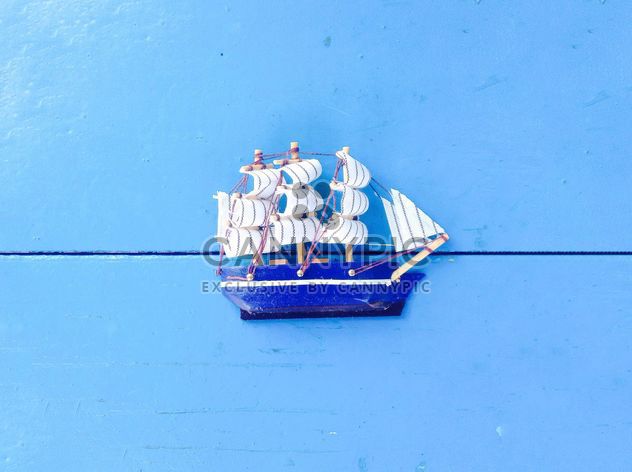 Toy ship on blue background - image gratuit #328185 