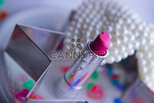 Pink makeup lipstick and pearls on a plate - бесплатный image #341485