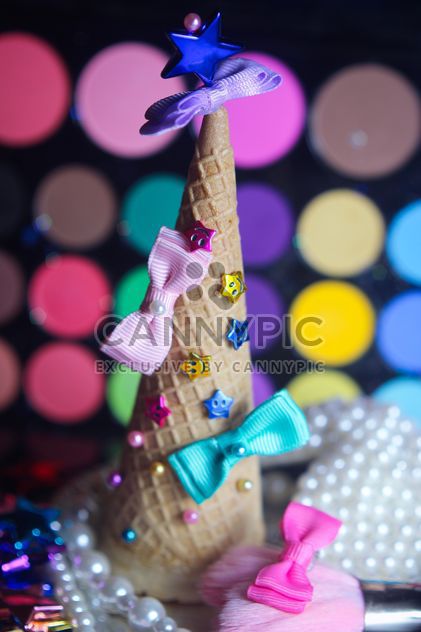 Icecream cone with ribbons and stars on a background of colorful eyeshadow palette - бесплатный image #341495
