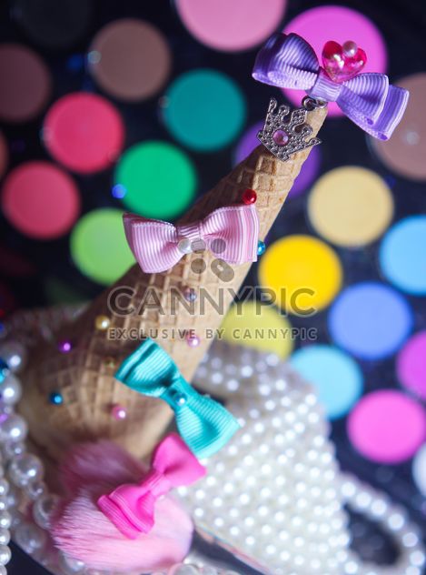 Icecream cone with ribbons and stars on a background of colorful eyeshadow palette - бесплатный image #341505