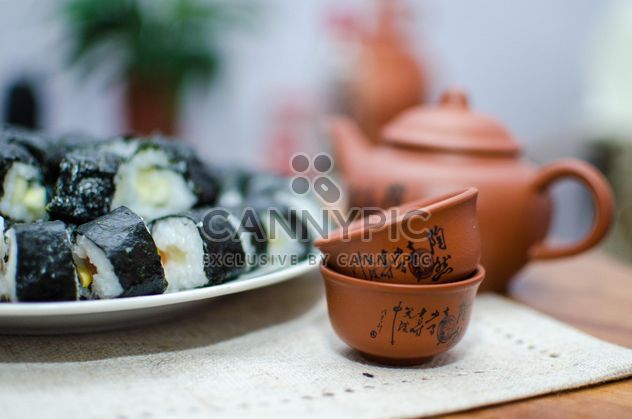 Clay cups, teapot and sushi rolls - image gratuit #347755 