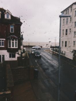 View on houses and cars on street through window - Free image #347765