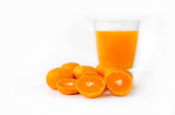 orange juice in glass on white background - image #452525 gratis