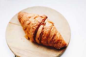 French croissant on wooden board. Close up. - Free image #456015