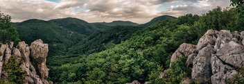 Forest and hills between two big boulders - бесплатный image #482435