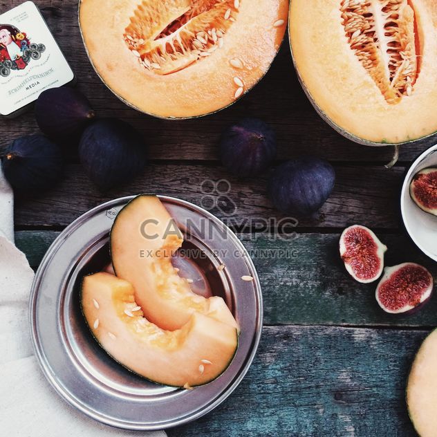 Melon and figs on wooden background - Free image #136245