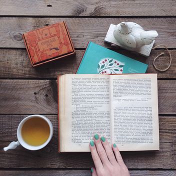 Cup of tea, candies and open book - image gratuit #136535 