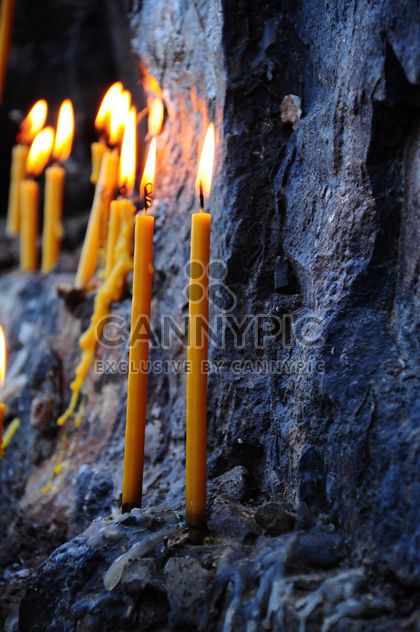 Burning candles on rock - image #183055 gratis