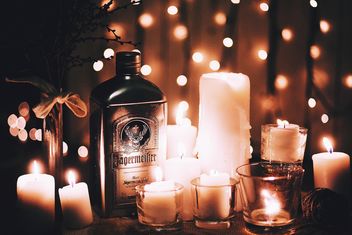 Candles and bottle of alcohol - image #183745 gratis