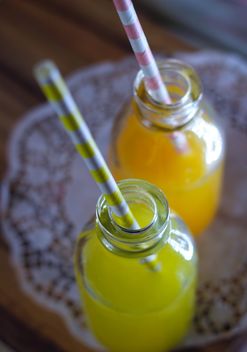 Bottles of lemon and orange juices - image #187635 gratis