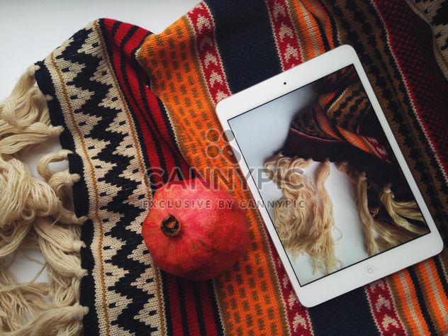 warm scarf and fresh pomegranate on white background - image #198765 gratis