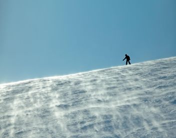 Silhouette of man on snowy hill - Free image #198865