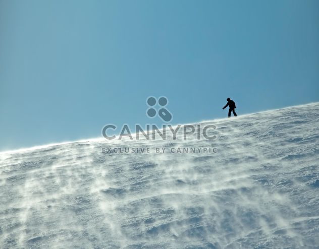 Silhouette of man on snowy hill - бесплатный image #198865
