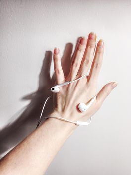 Earphones on female hand on white background - бесплатный image #198995