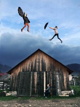 Boy looking at the girl and guy flying with umbrellas over the wooden house, #mylook - бесплатный image #271695
