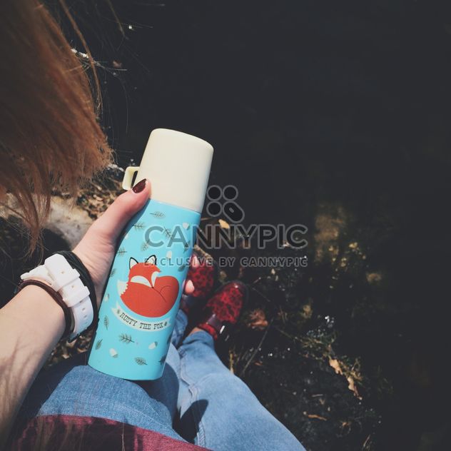 Colored thermos in female hand - image gratuit #271715 