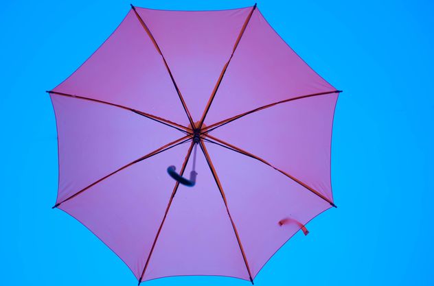 Pink umbrella hanging - image #273085 gratis