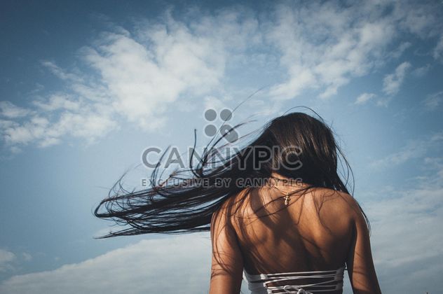 Rear view of girl with flying hair - image #301565 gratis