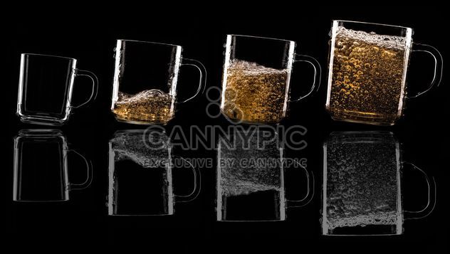 Glass cups on black background - image gratuit #303225 