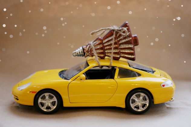 Yellow toy car and Christmas decoration - image gratuit #304095 