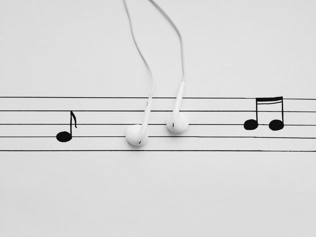 Earphones and notes on white background - бесплатный image #304105