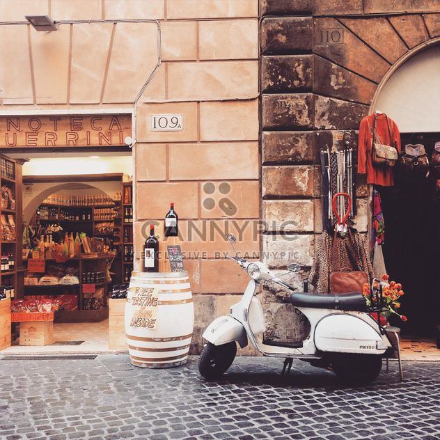 Retro Vespa scooter in street of Rome - image #332275 gratis