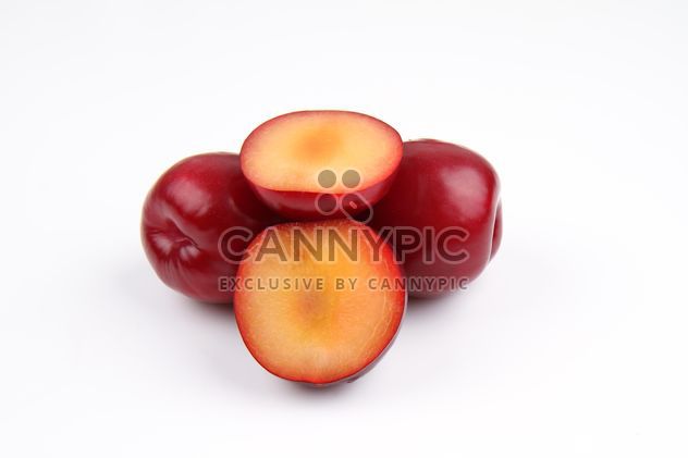 Red plums isolated on white - Free image #343555