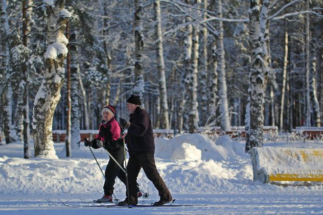 Elderly couple skiing in winter park - бесплатный image #344635
