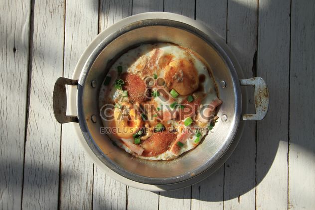 Fried eggs with sausage and green onion in pot - Free image #346975