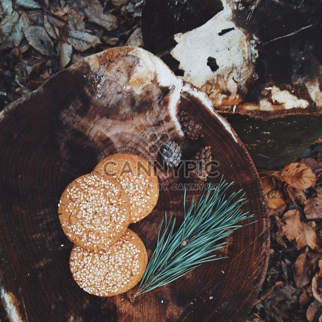 Cookies with sesame on wooden stump - Free image #347175