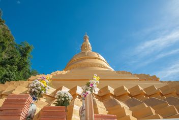 Thai temple against blue sky, view from below - Free image #347195