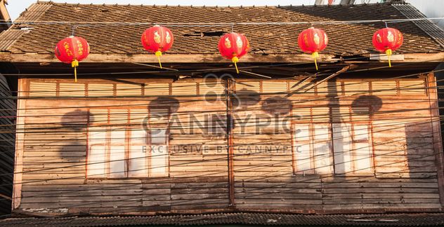Old wooden house with red decorations - image #347205 gratis