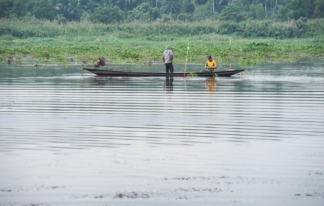 Fishermen in fishing boat on river - бесплатный image #347285