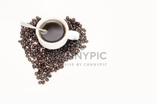 cup of coffee and coffee beans laid out in the shape of heart - бесплатный image #452565