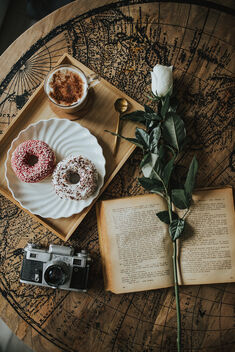 Donnuts, coffee, analog camera, old book and white rose from above. - Free image #478215