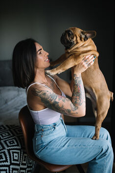 Happy tattooed woman hugging her lovely black dog. - Free image #481115