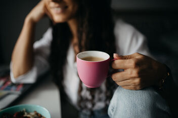 Happy girl holding pink cup of coffee at home. - Free image #481255